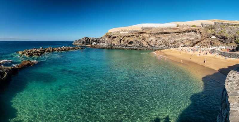 Panorama of Playa Abama beach, Tenerife, Canary Islands, Spain. Turquoise ocean water and luxury sand beach