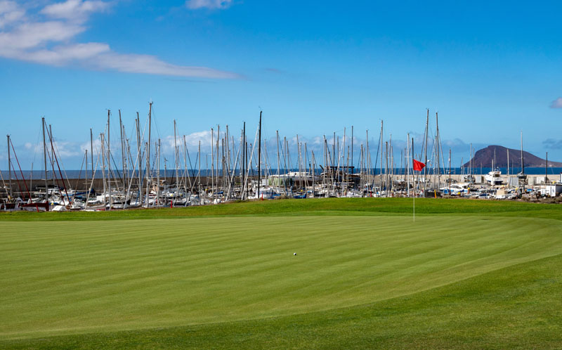 Green lawn grass on year-round outdoor golf course located nead yacht harbor on Tenerife, Canary islands, Spain in winter